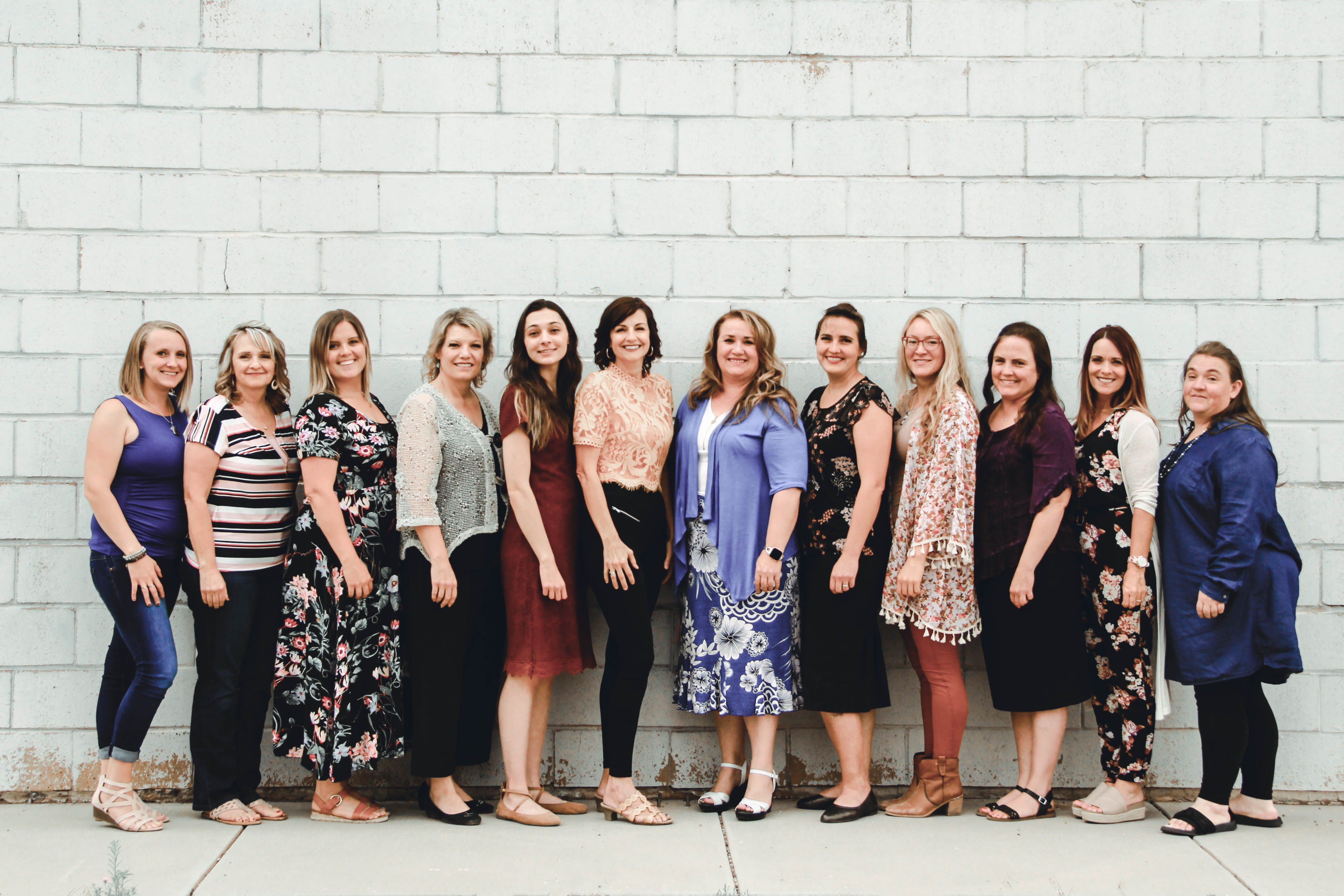 Cherish Families staff posing in front of the beautiful red mountains of Southern Utah