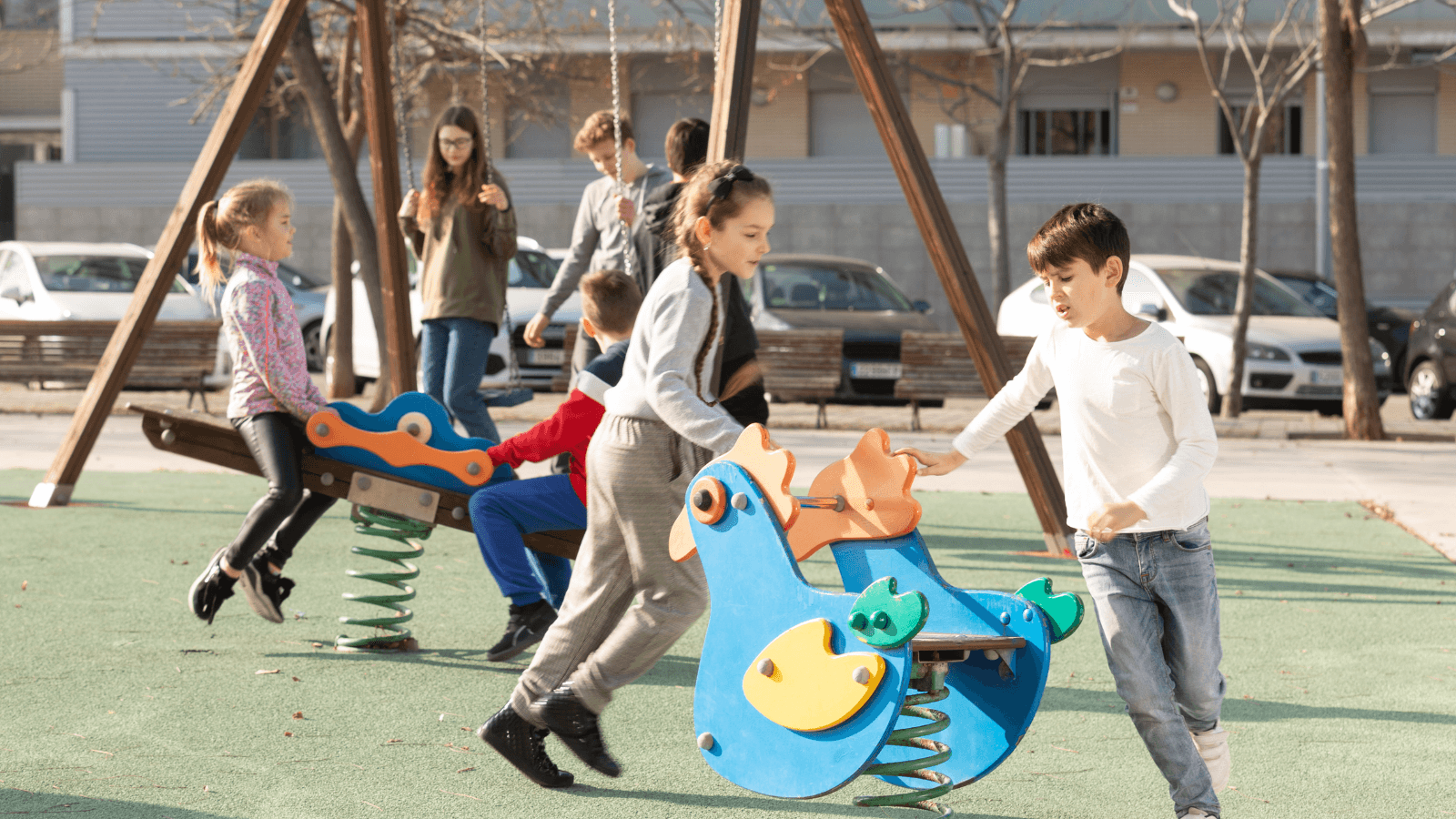 children running around and playing on an outdoor playground set 