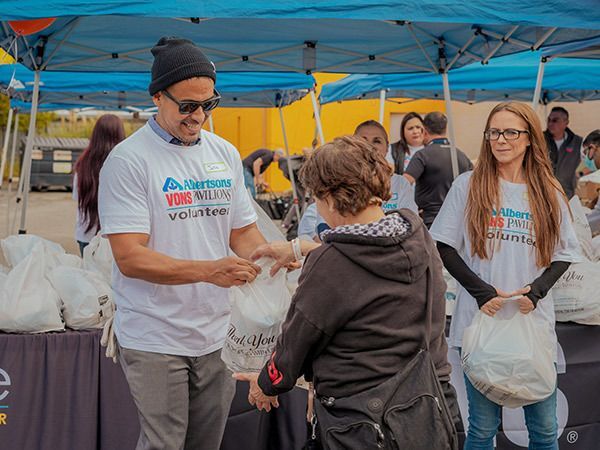 Partner volunteers take time to assist during our food giveaway event.