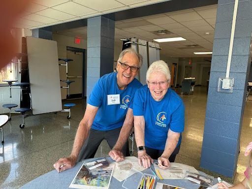 Volunteers setting out art supplies for students
