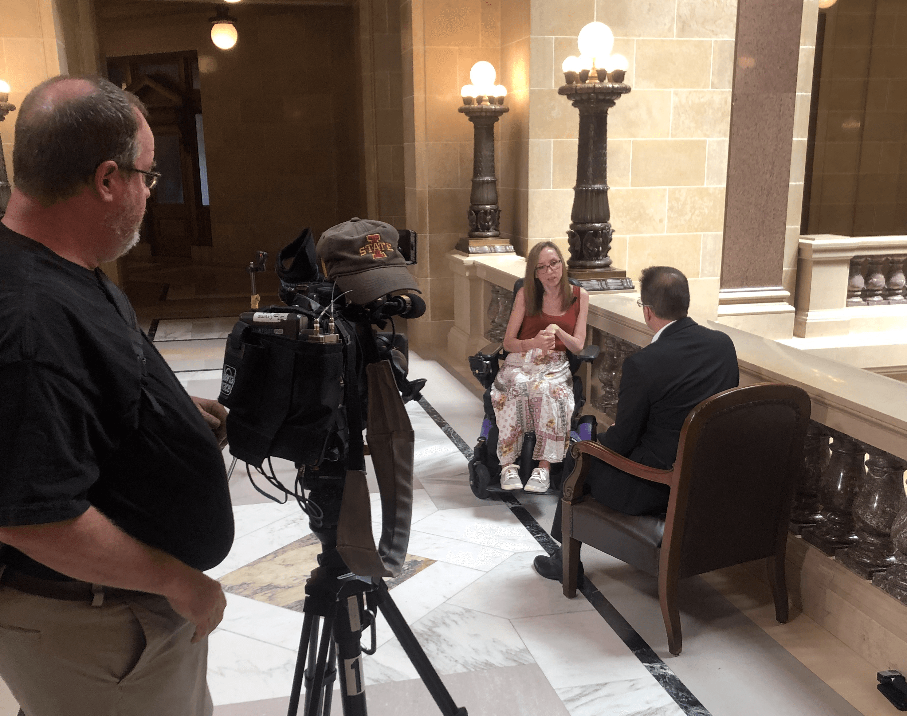 camera man and two interview subjects talking