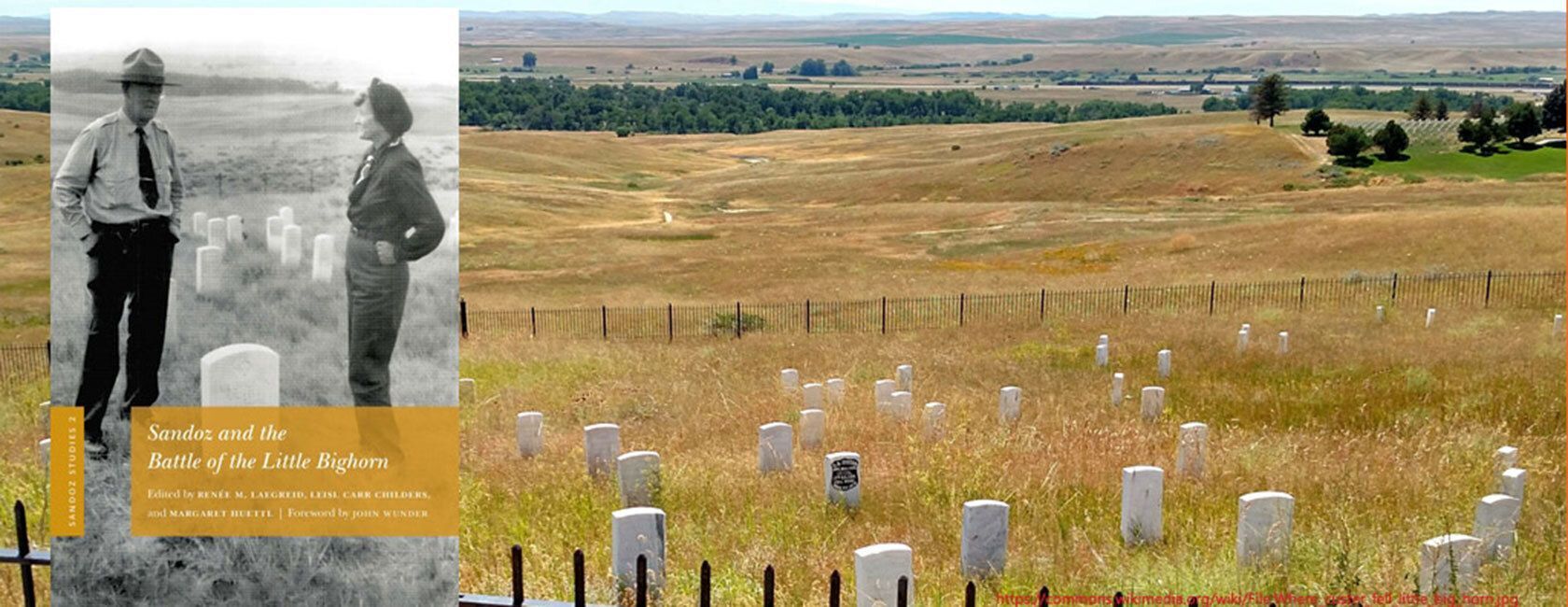 Fenced in gravesite with multiple white headstones.