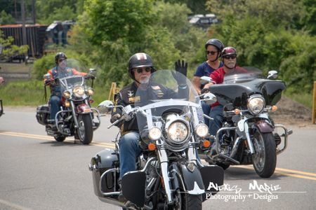 Three motocycles being ridden by 4 people, with the front motorcyclist waving to the camera. "Alexis Marie Photography & Design" logo in the bottom right corner