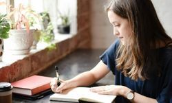 woman writing letter on paper