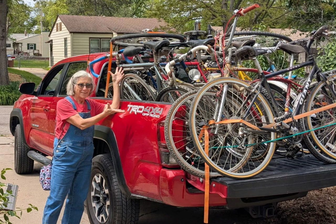 Woman donating a pickup load of bicycles.
