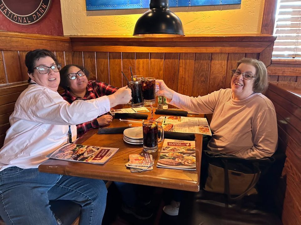 Chambers Bridge residents cheering their drinks at dinner