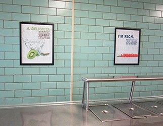 School café serving line with 2 food education posters on wall, white posters with nutrition facts