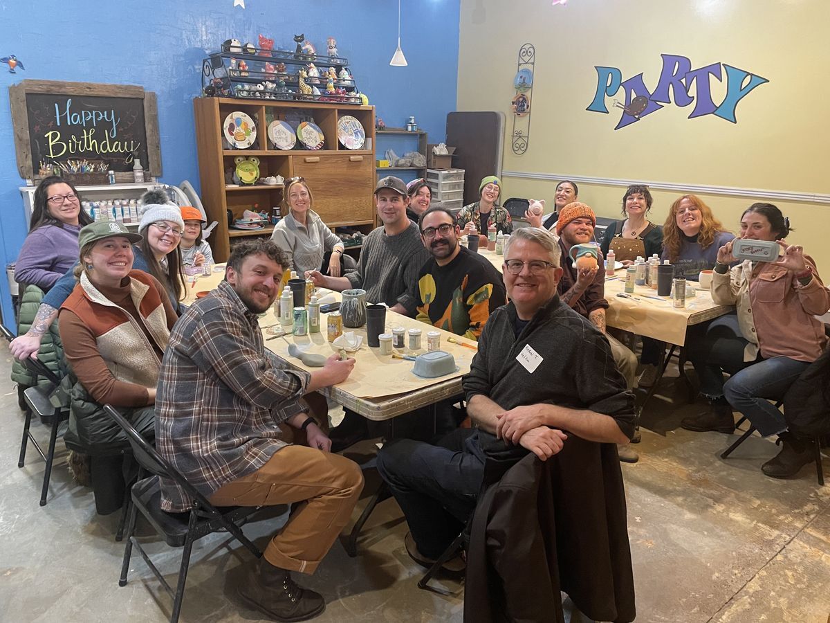 [Image Description: MCC staff pose while painting ceramics.]