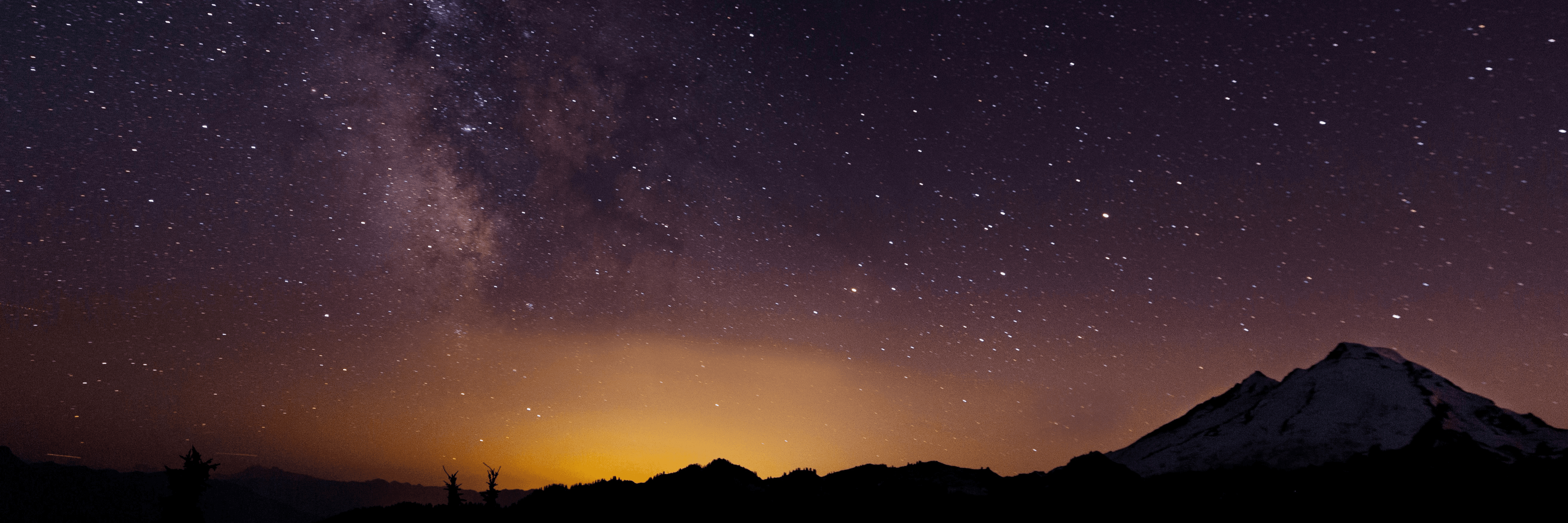 Starry night sky with the beginning of sunrise