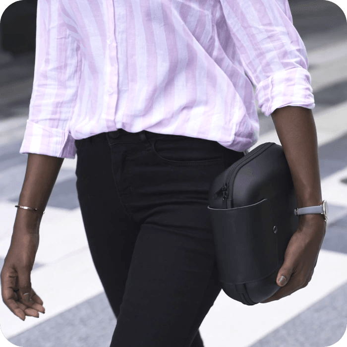 image of a person walking with a small black bag that holds the portable display