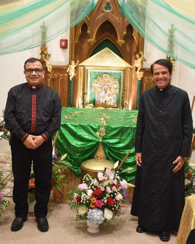 Father Raúl Cárdenas, pastor, left, and Father John Mericantante, pastor emeritus, stand next to the 16th century icon of Our Lady of Bethlehem at St. Mary Church in Pahokee.