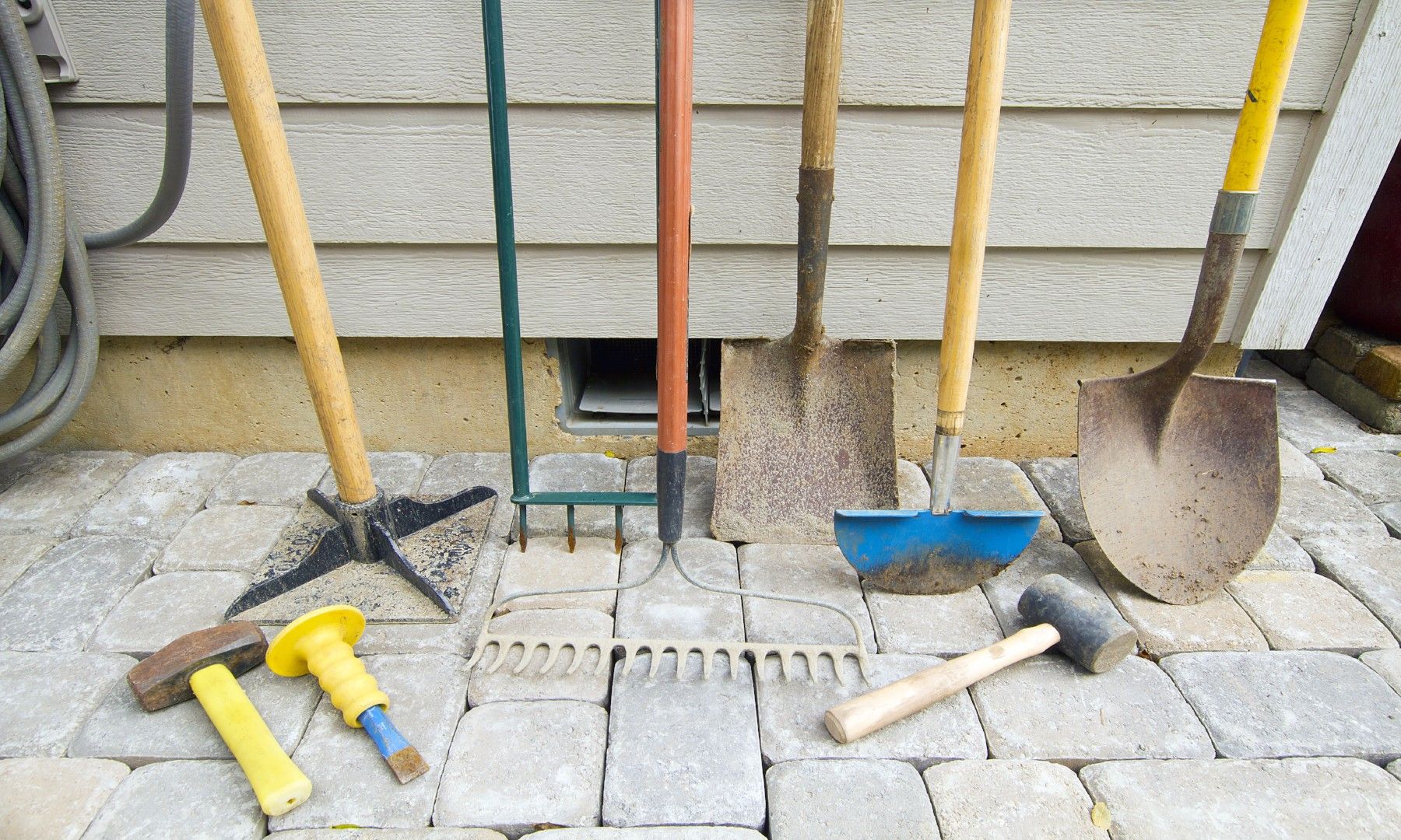 rakes shovels and assorted yard tools
