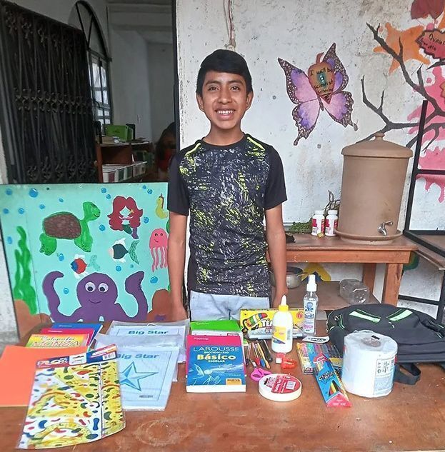 Boy with school supplies.