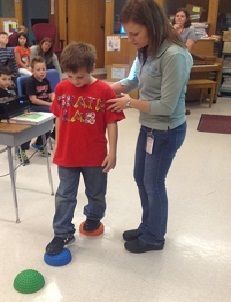 Teacher working with a student.