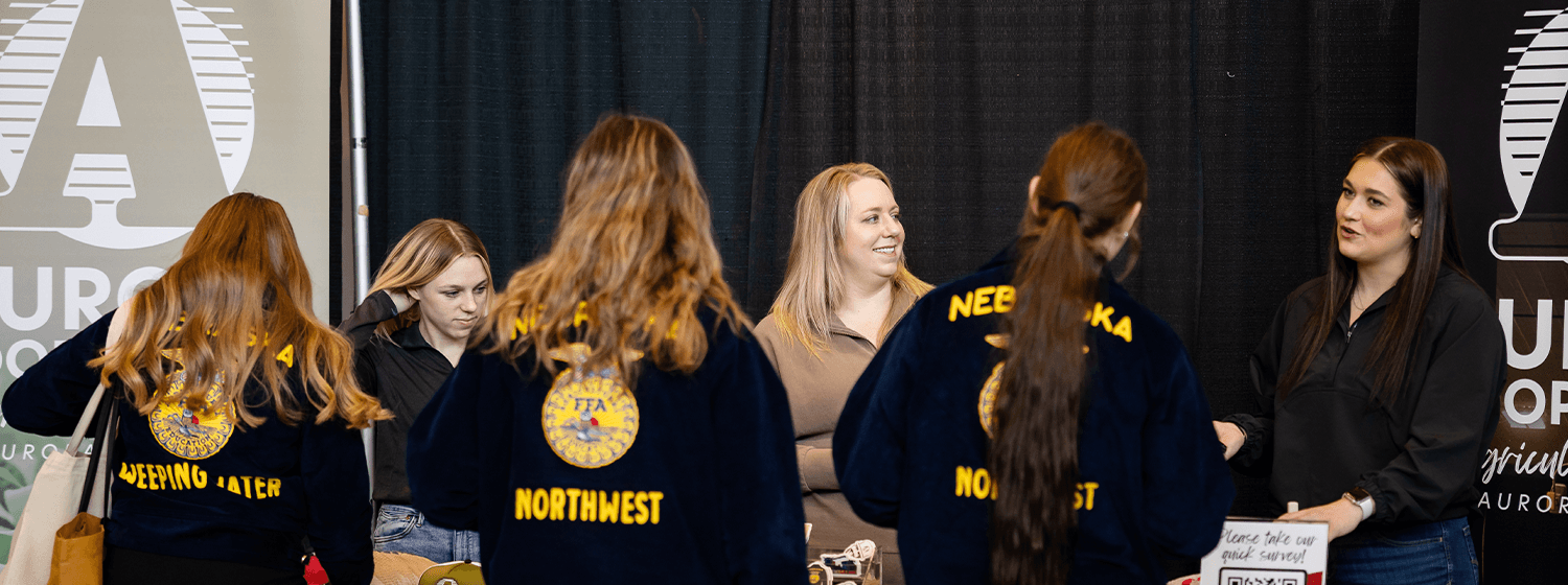 FFA students from Northwest visiting with sponsors from Aurora Cooperative at convention career fair