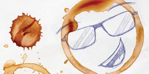 Sketch of a man wearing glasses, with a coffee stain visible on the postcard background.