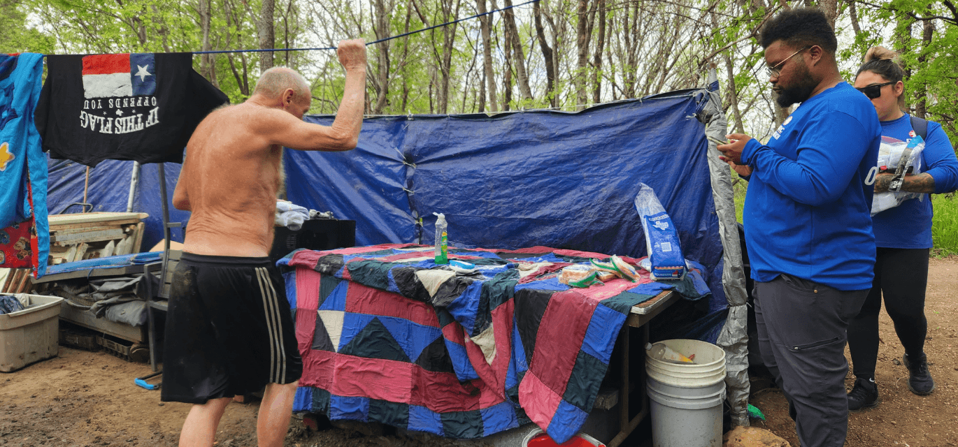 A family that just moved into their apartment, smiling and happy to be home after surviving unsheltered homelessness.