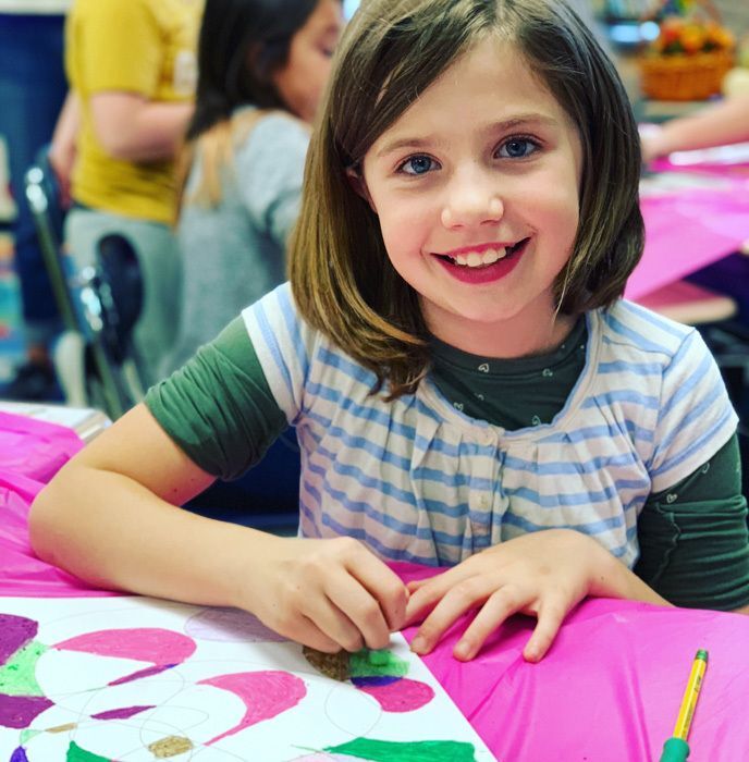Young girl painting during Art Masterpiece