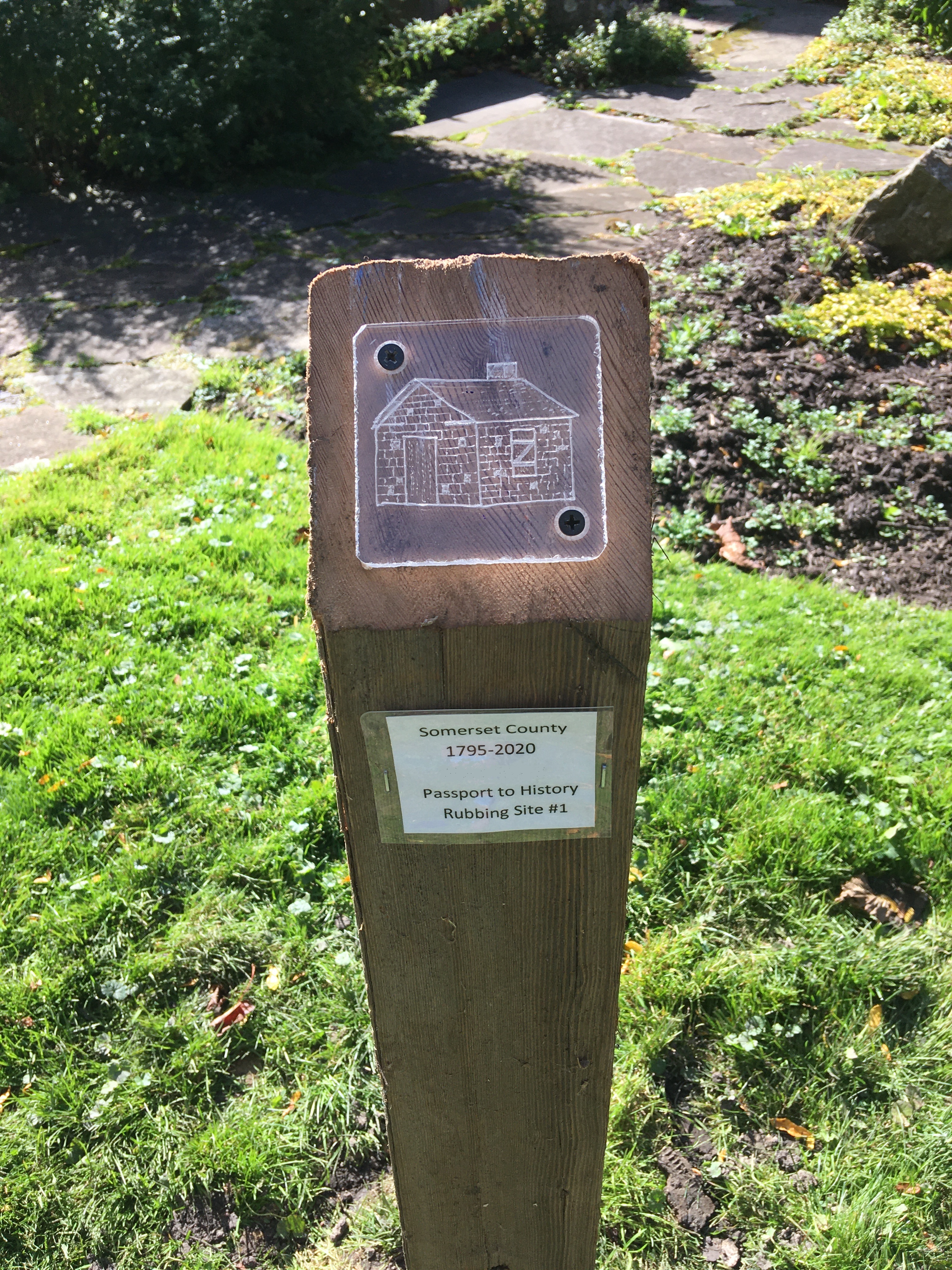 Wooden post with etched plexiglas plate attached