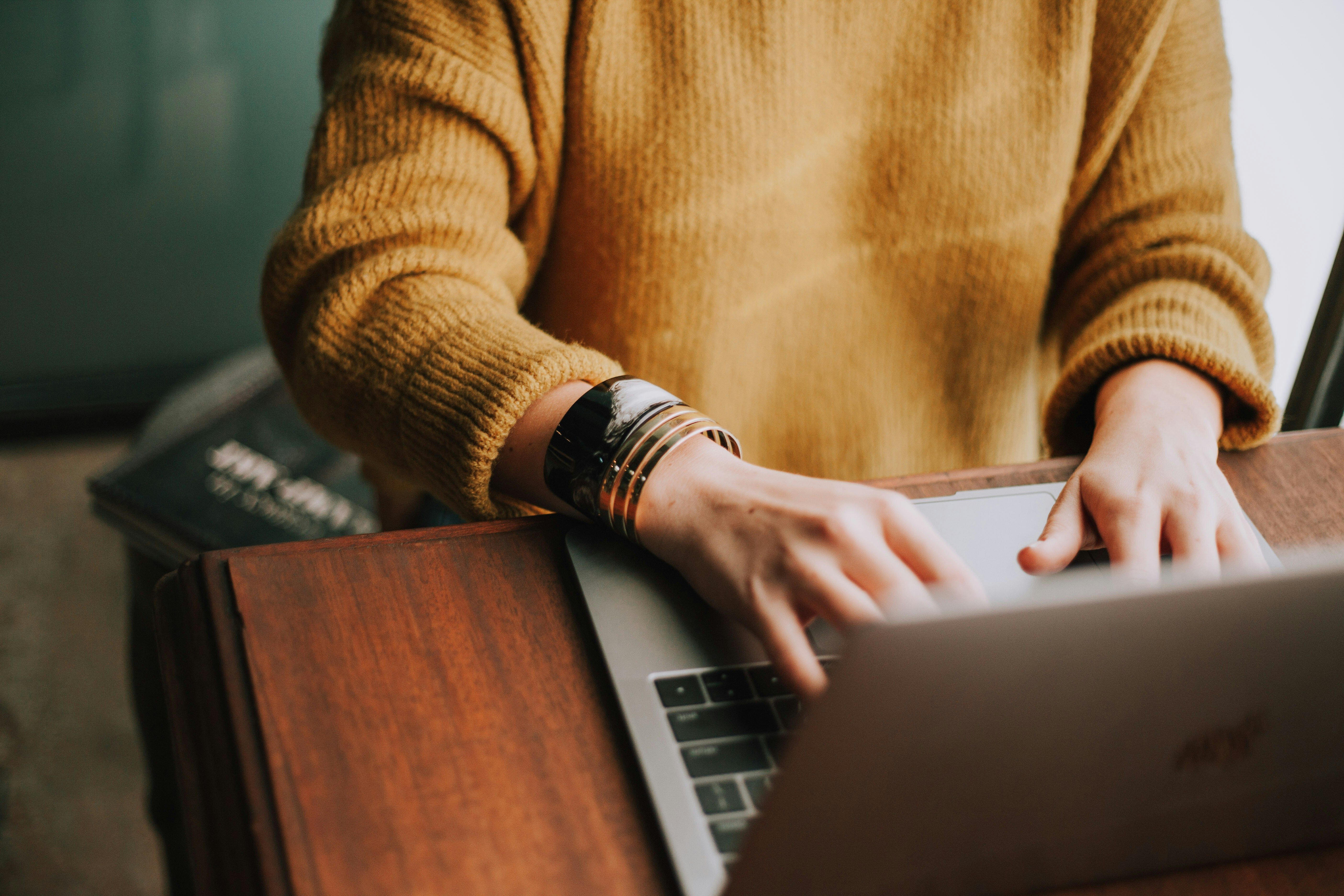 Photo of a woman typing on her computer. 