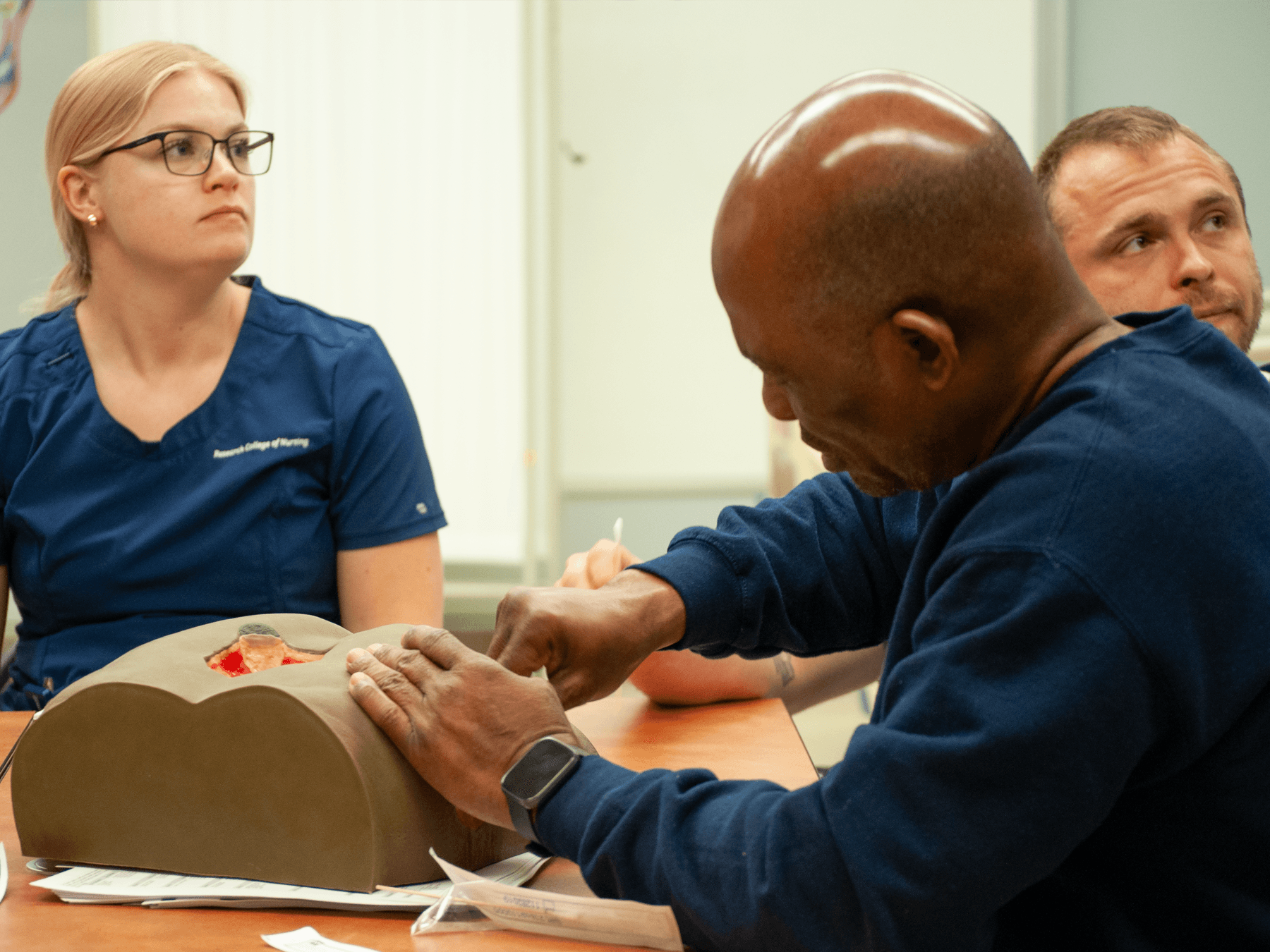 nursing student measuring wound