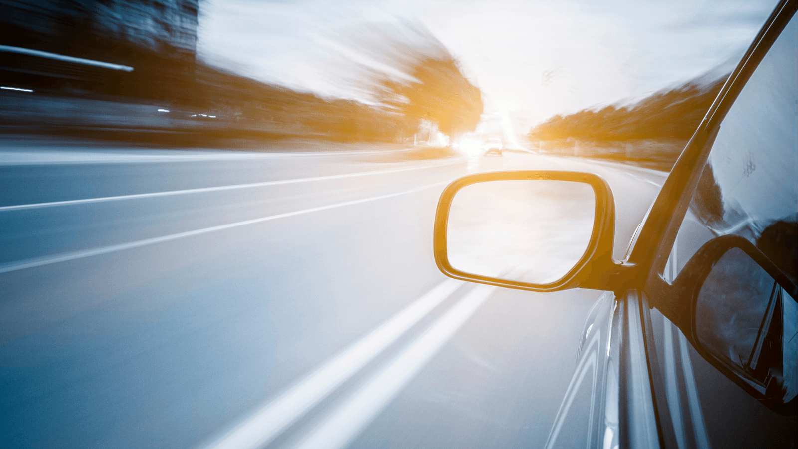 View from driver's seat of car driving down road