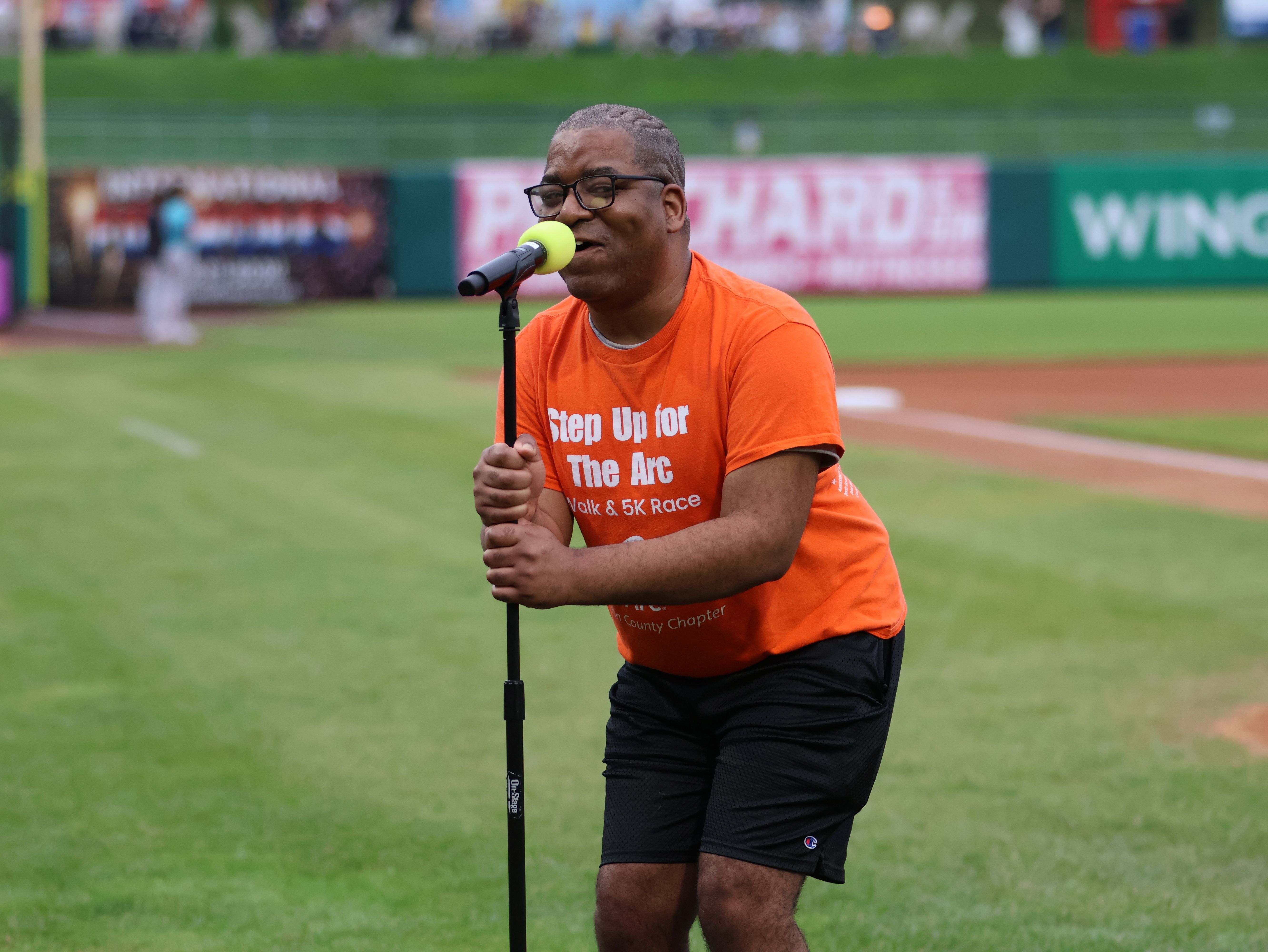 Resident singing the National Anthem