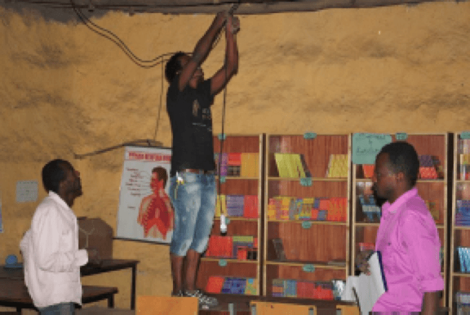 Men installing wires in the school.