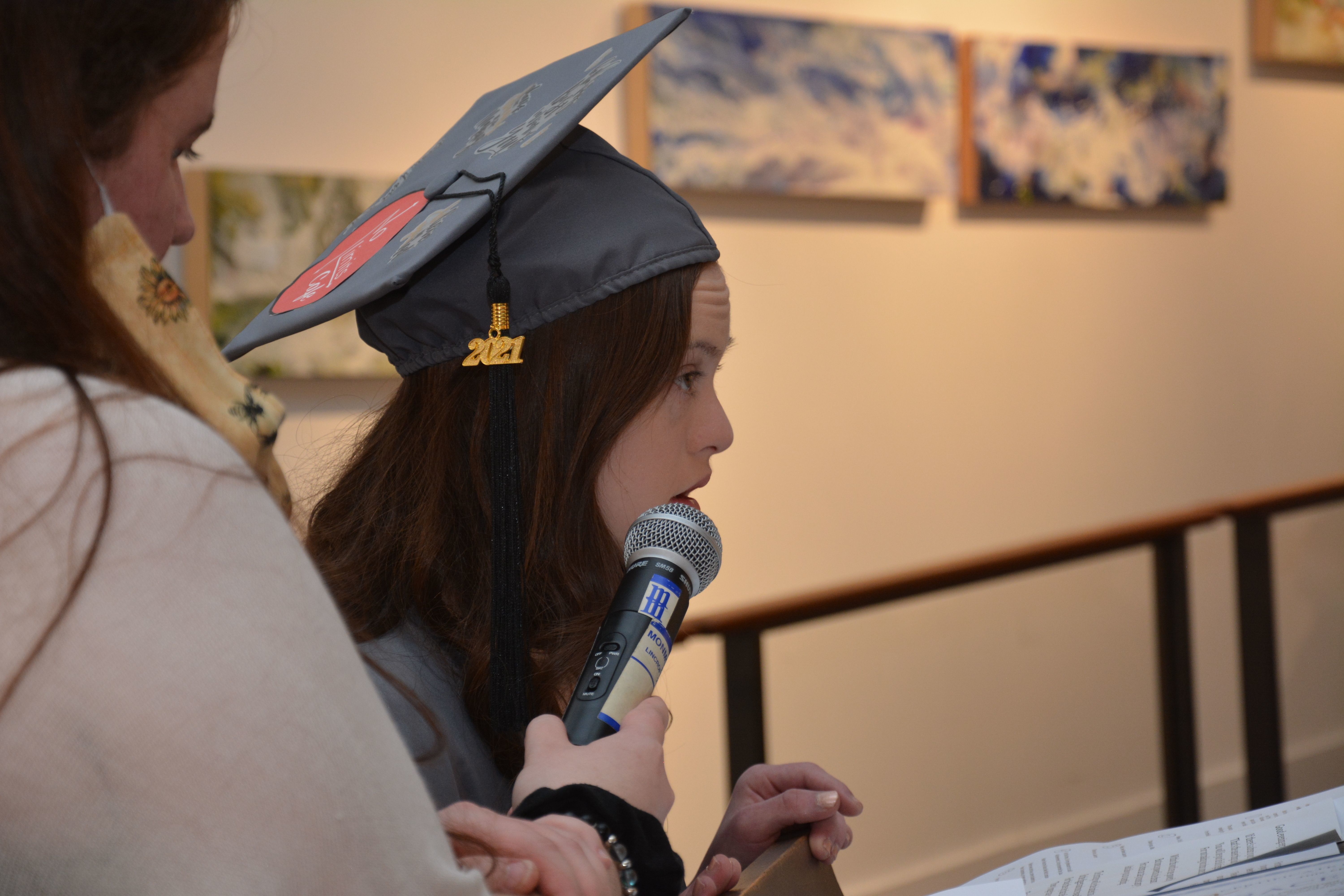 A female student from the KACH program wearing a graduation cap with a 2021 tag.