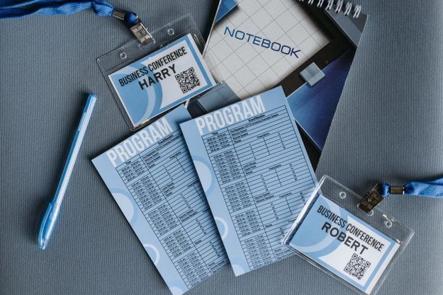 Two printed conference badges from one template showing different names and QR codes, an example of variable data printing in action.