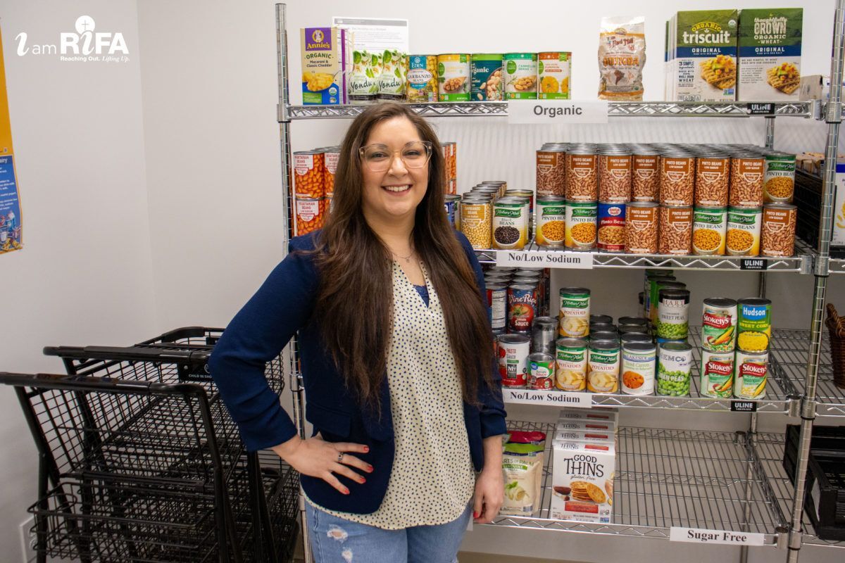 Woman standing by shelves with organized canned goods