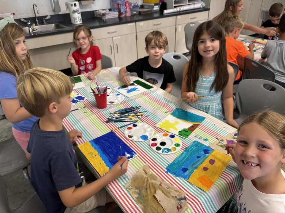 Elementary classroom with students sitting on rug