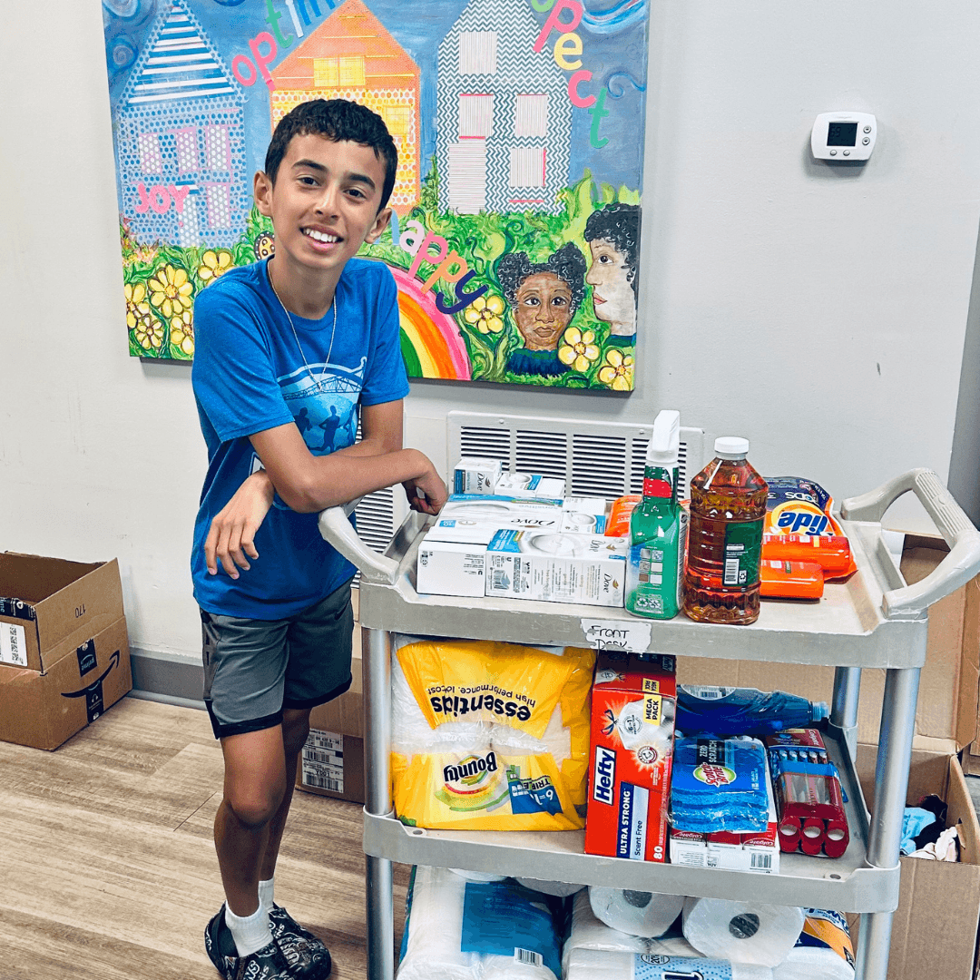 Photo of HFF volunteer, Micah, dropping off cleaning supplies and toiletries at Home for Families