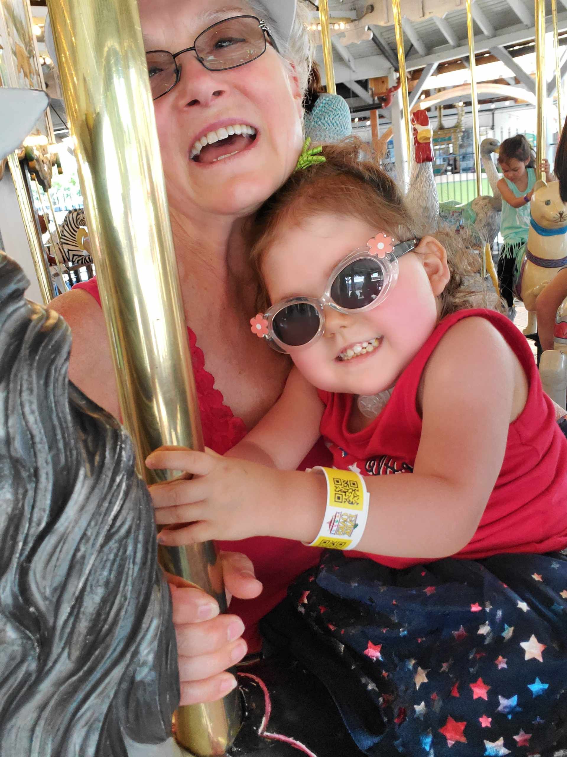 Saylor on the Merry-Go-Round with her Nurse