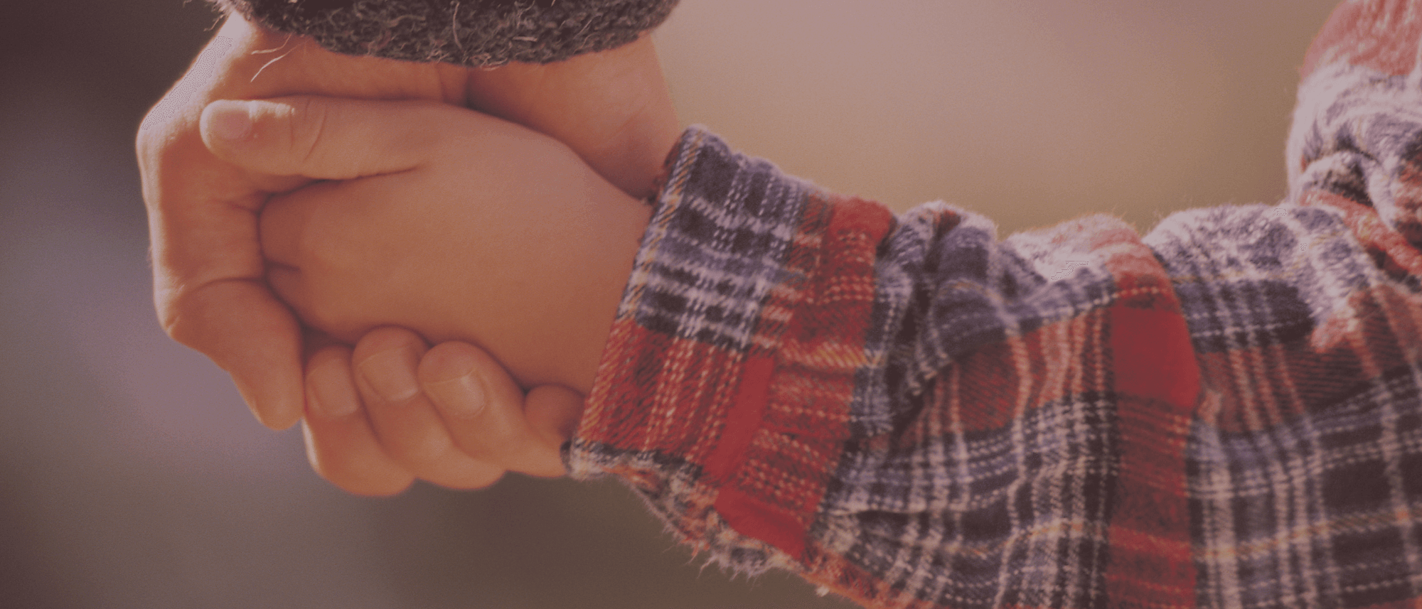 image of a boy holding his mom's hand