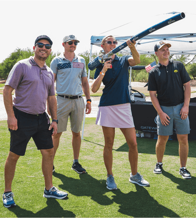 Golf foursome at CEF golf tournament with female golfer shooting ball with the cannon shot