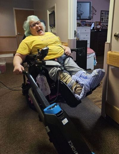 Amy and her helper, Beth, are dressed in matching silly pajamas and smile at the camera