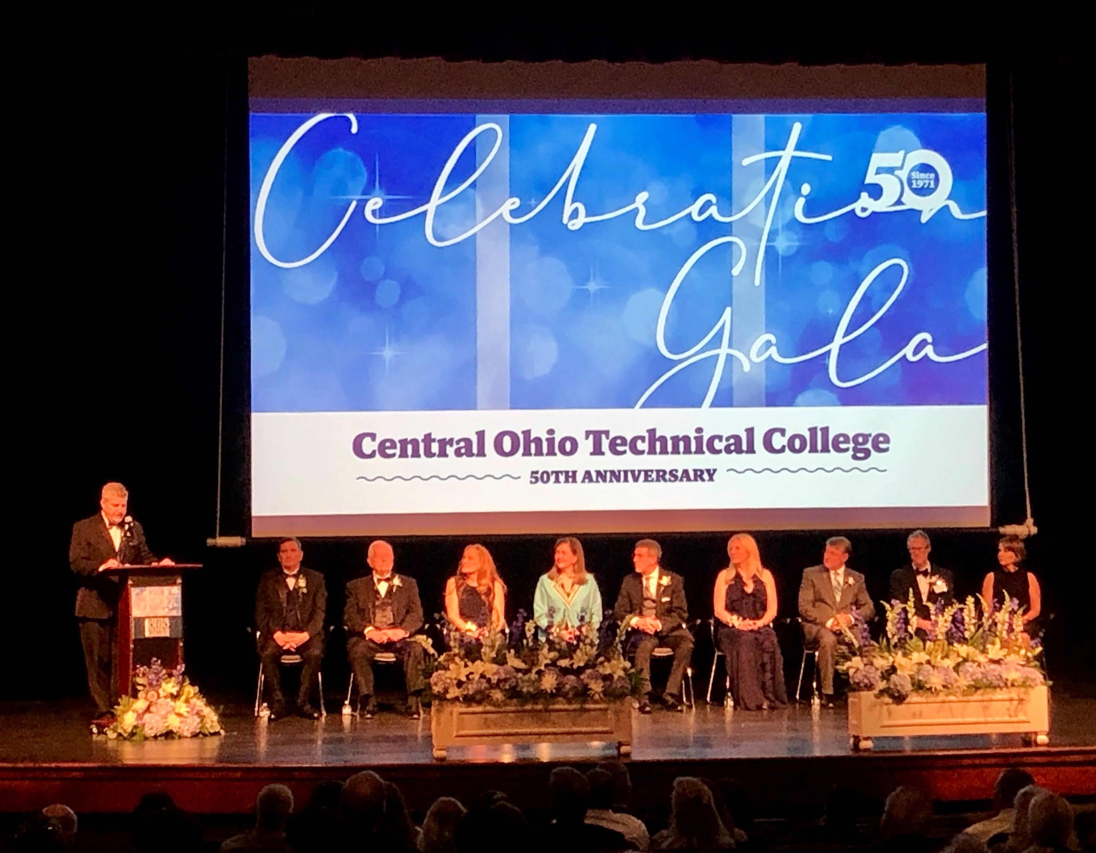 Recipients of the Legends of Loyalty awards are seated on stage as they receive their awards.