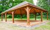 A wooden pavilion is shown big enough to be dance floor for a wedding.