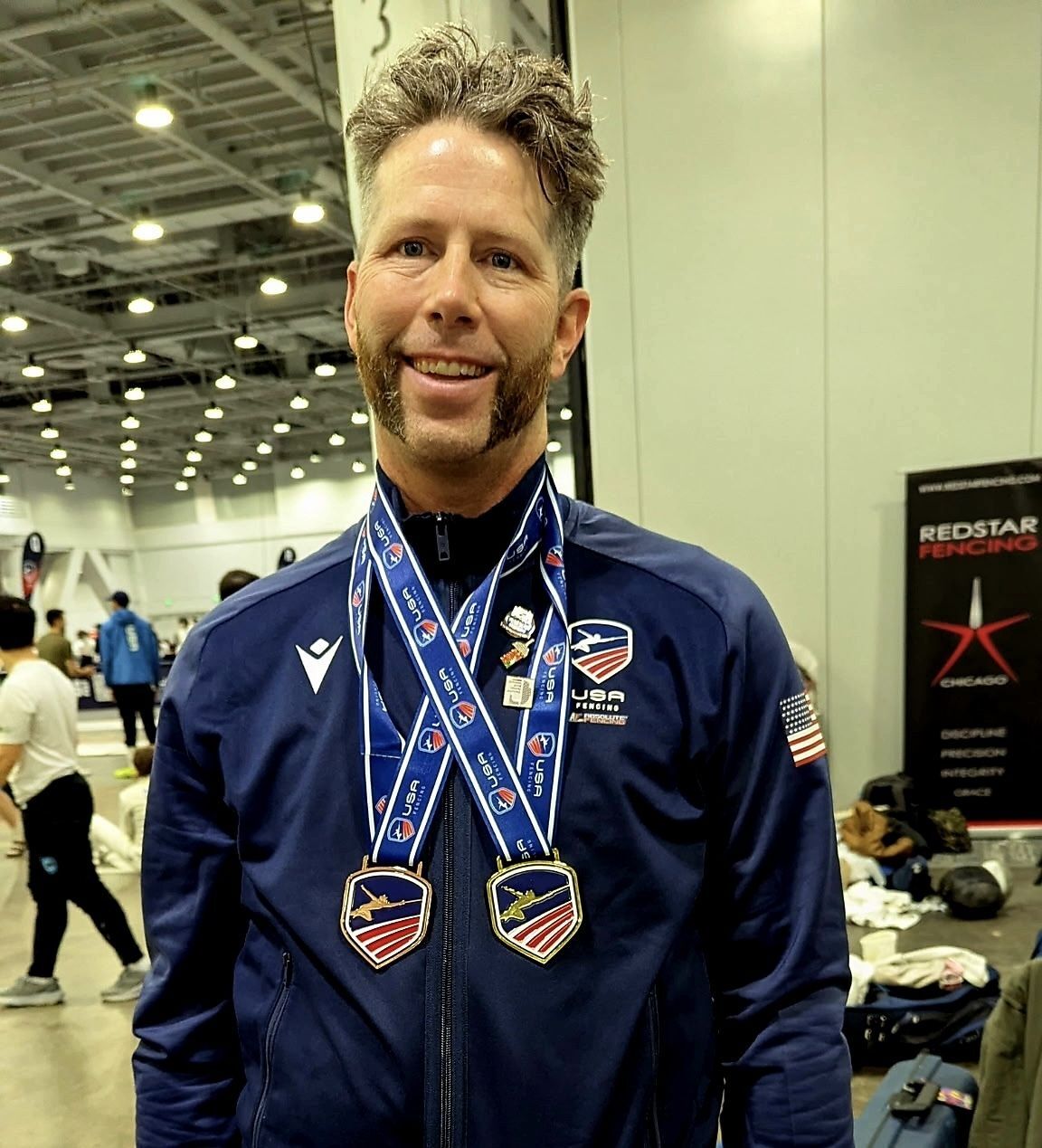 Josh Bush poses with medals around his neck
