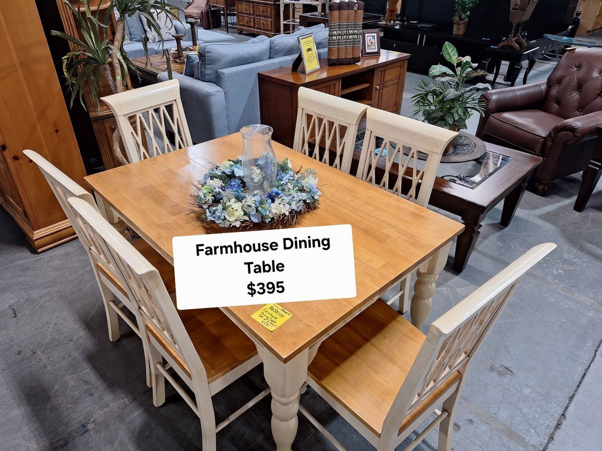 Charming light wood farmhouse dining table with 4 chairs and floral centerpiece, available at Habitat ReStore Zephyrhills – $395