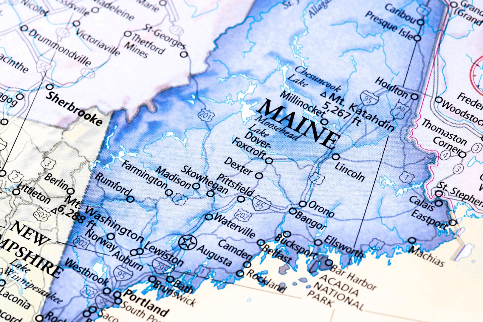 a close view of a map of Maine, detailed in shades of blue with town names visible