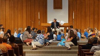 Children at the altar listening to children's message.