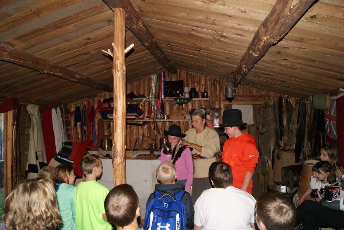 Children trying on furs during their field trip.
