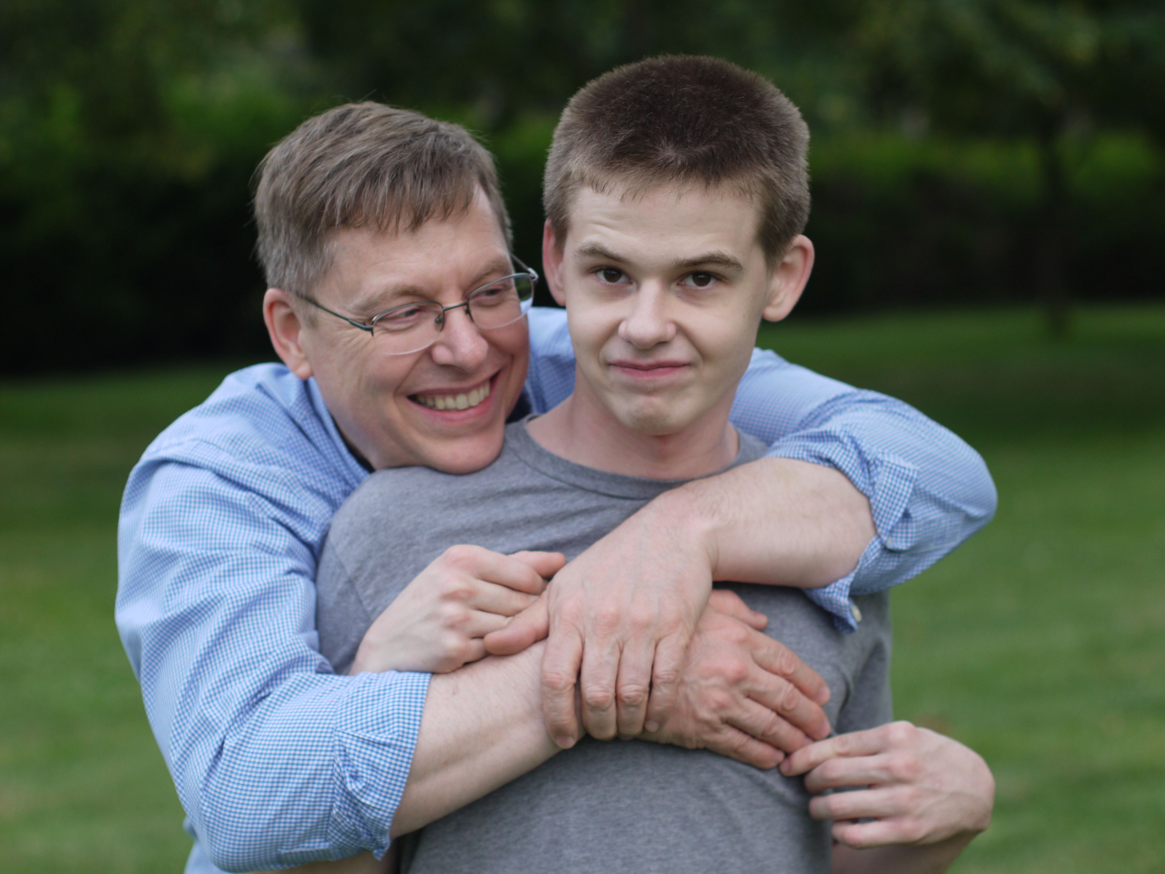 Dad and son embrace