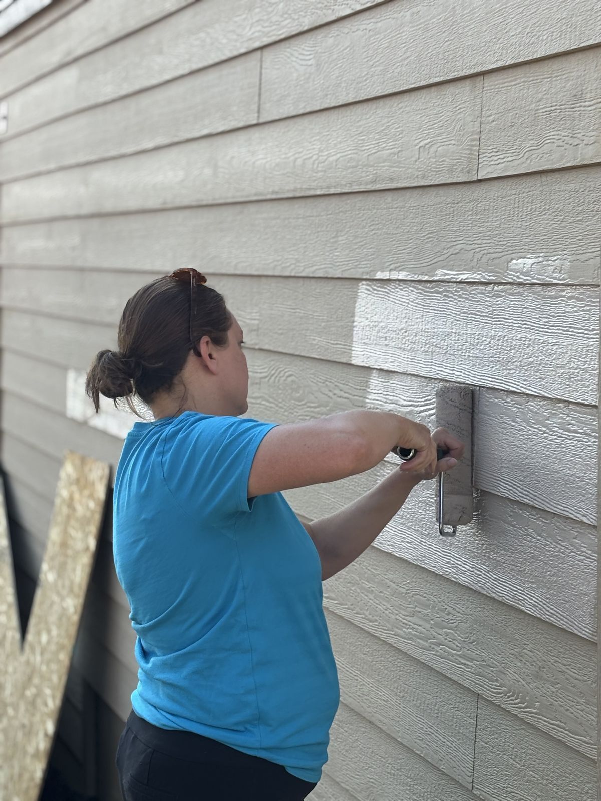 Habitat Colorado Build: Volunteer Painting outside of the garage