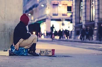 Homeless man waiting outside of a shelter.