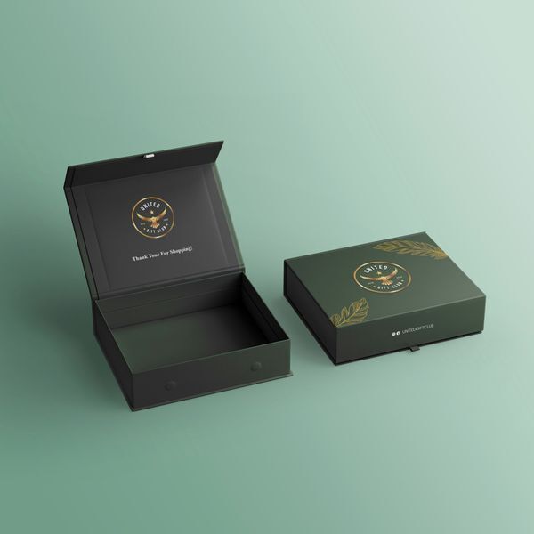 Open and closed dark green boxes with gold foil logo and thank-you note, showing packaging design trends for gifting brands.