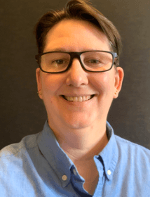 Photo of Laurie,  white woman with short brown hair and glasses.