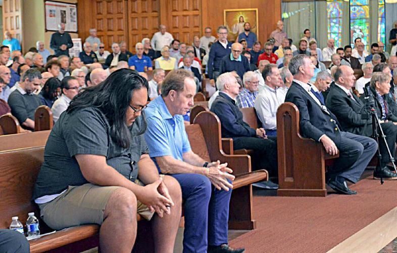 Men at the rally pause for a moment of prayer.